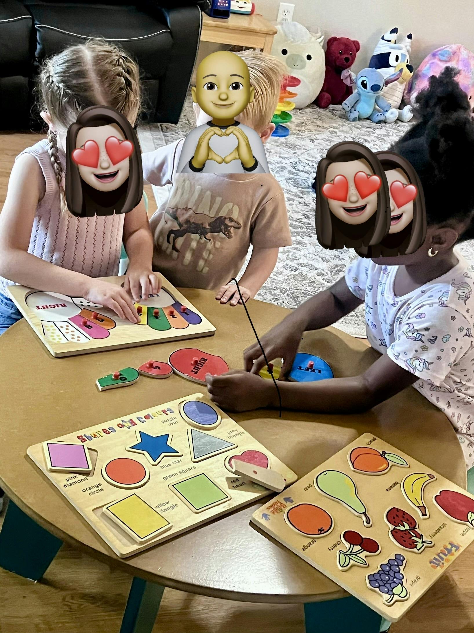 Three children sitting at a round table playing with wooden educational puzzles