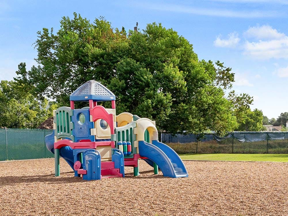children's playground with colorful climbing structure and slides