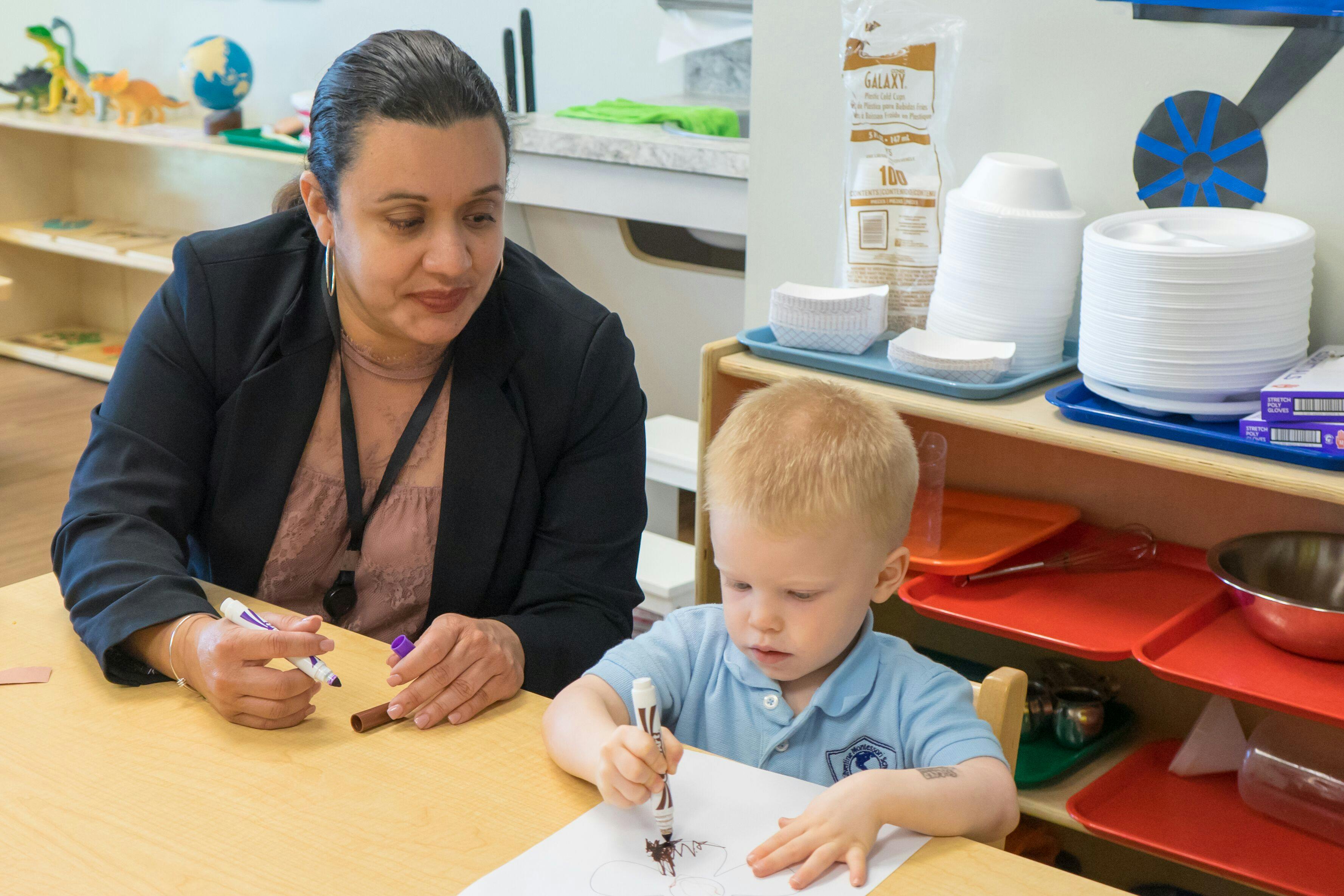 Adult and child drawing at a table