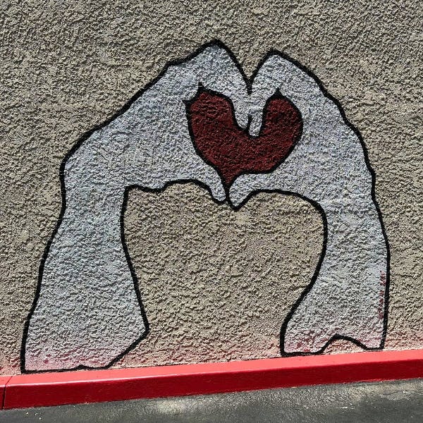 Mural of two hands forming a heart shape