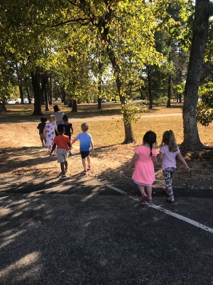 Children walking on a path in a park