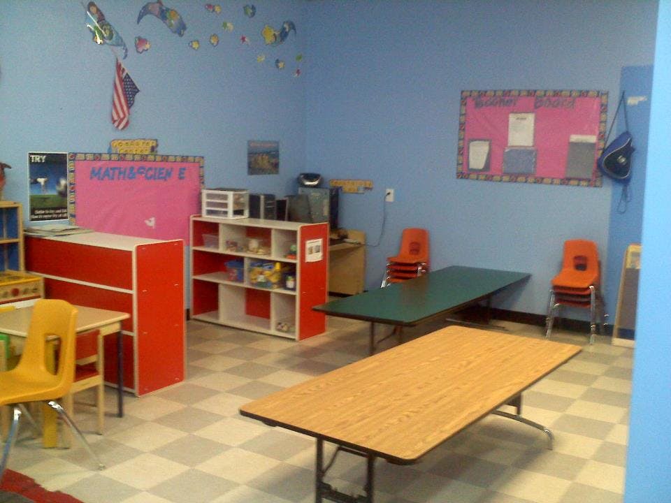 Classroom with tables, chairs, and storage units
