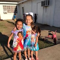 Three children standing together outdoors
