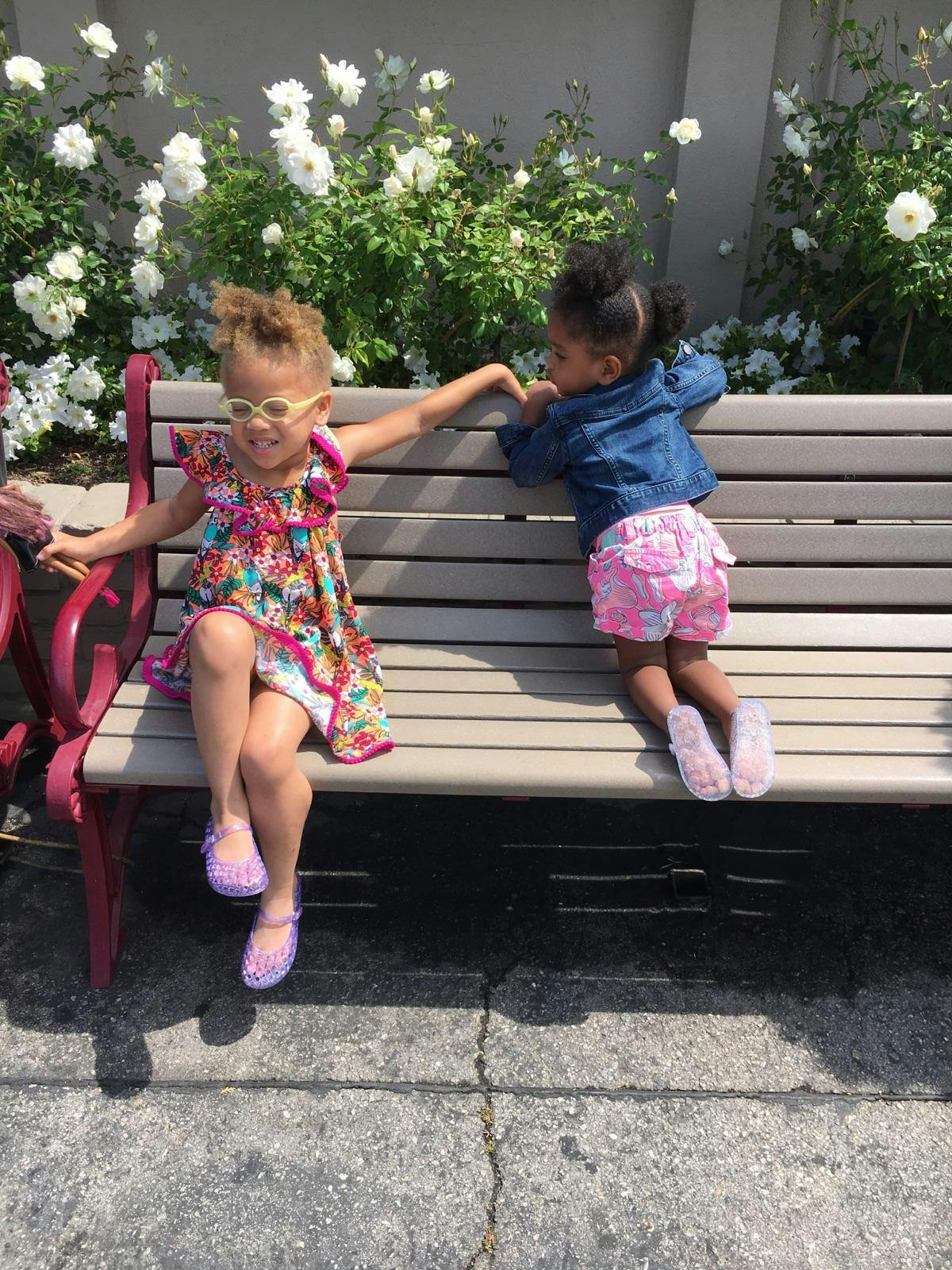 Two children on a park bench