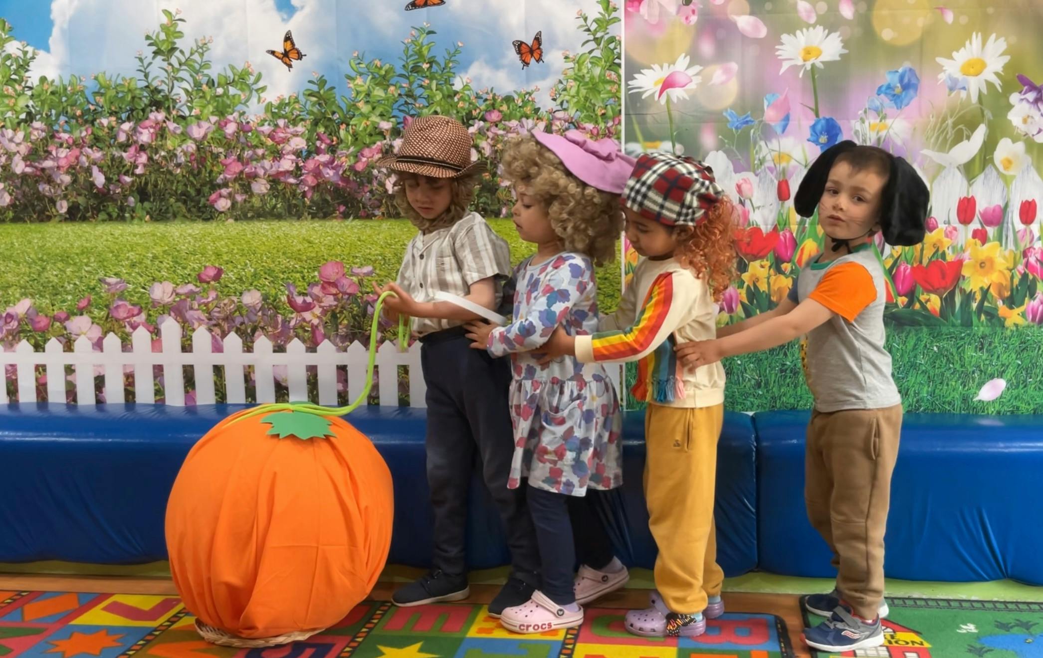 Children in costumes holding hands in a line