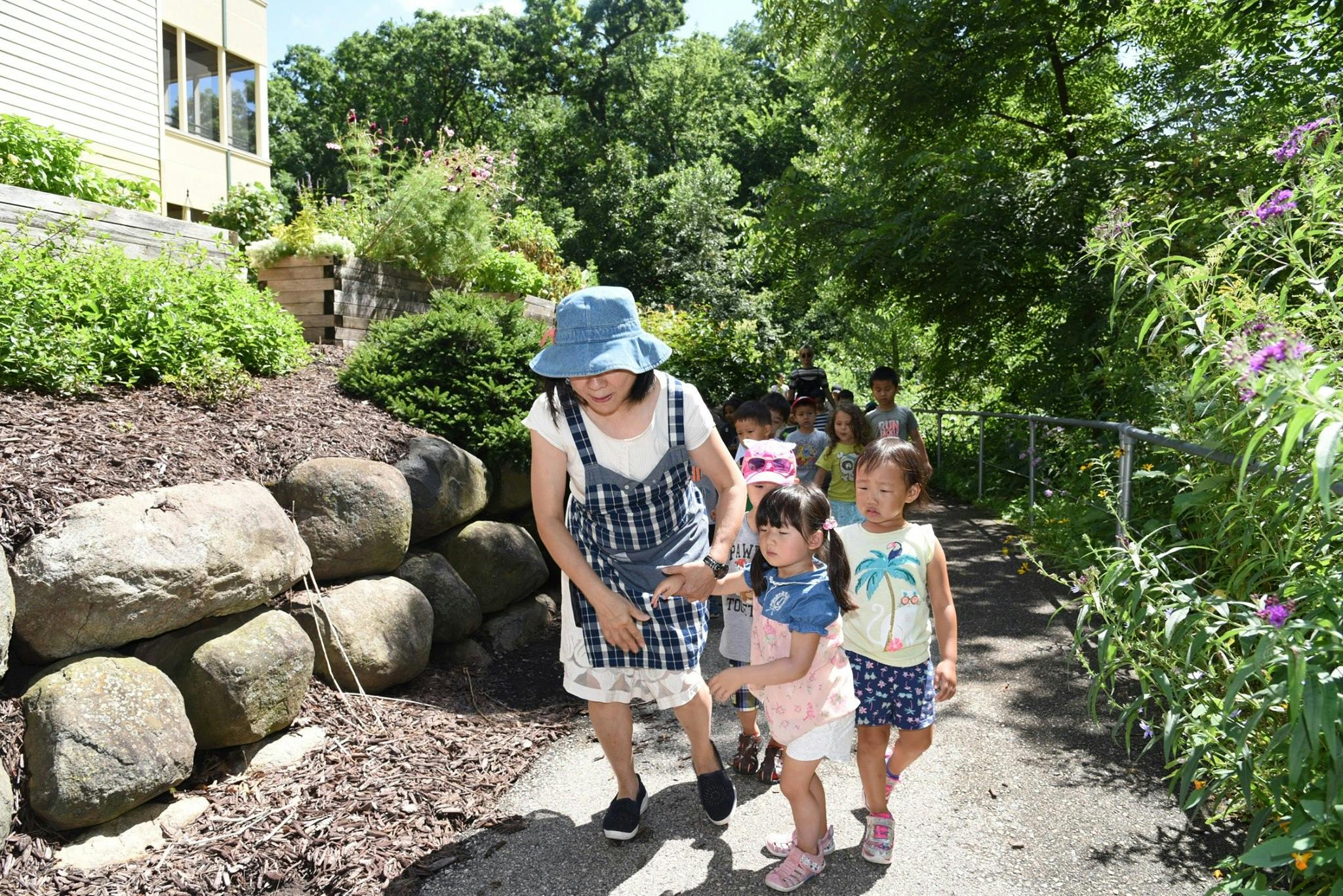 Adult and children walking on a path outdoors