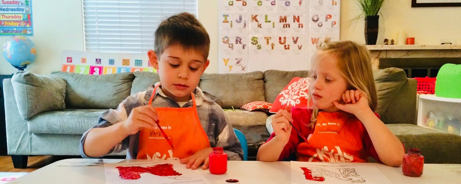 Two children painting at a table