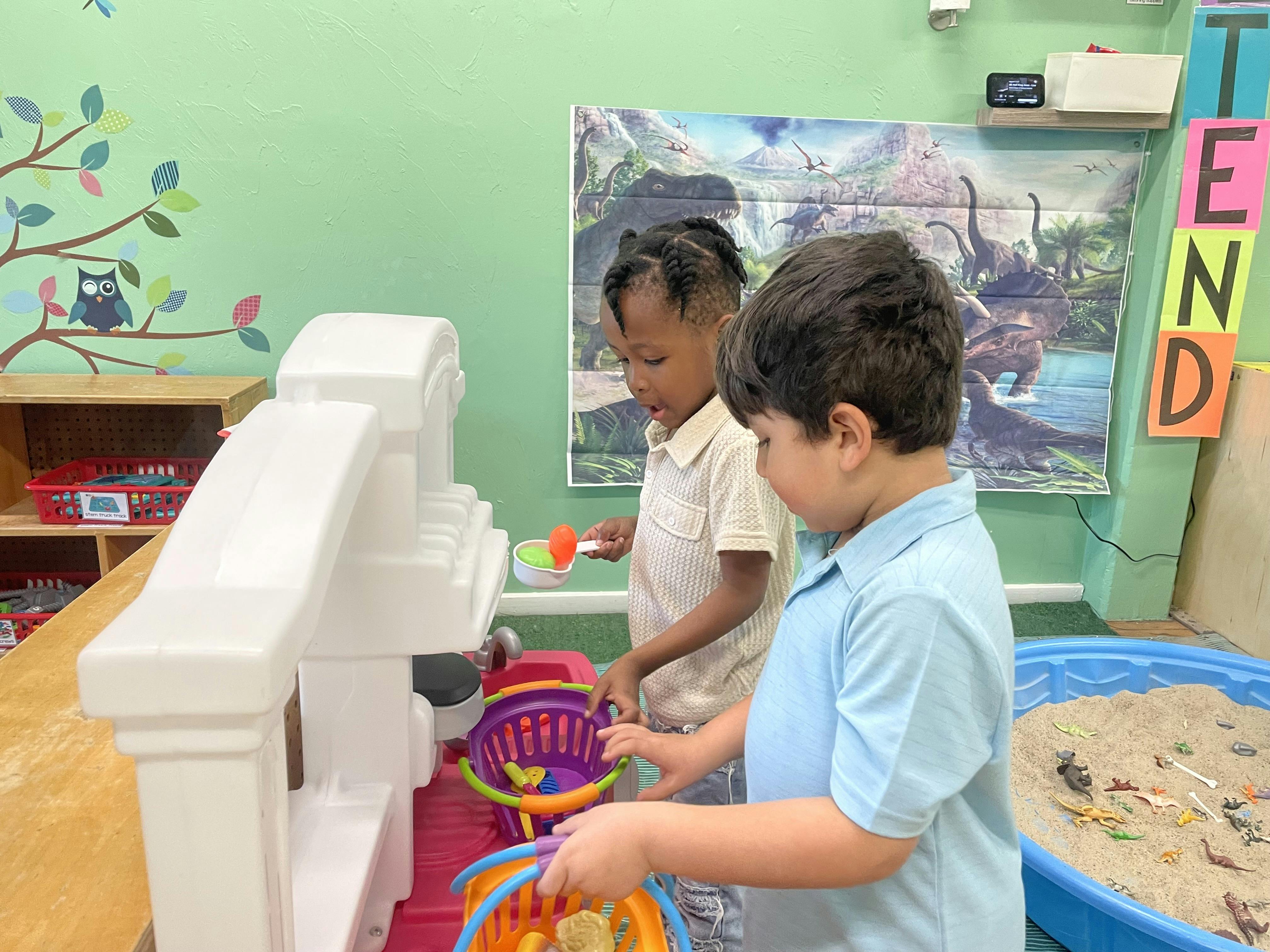 Two children playing with toy kitchen accessories and baskets