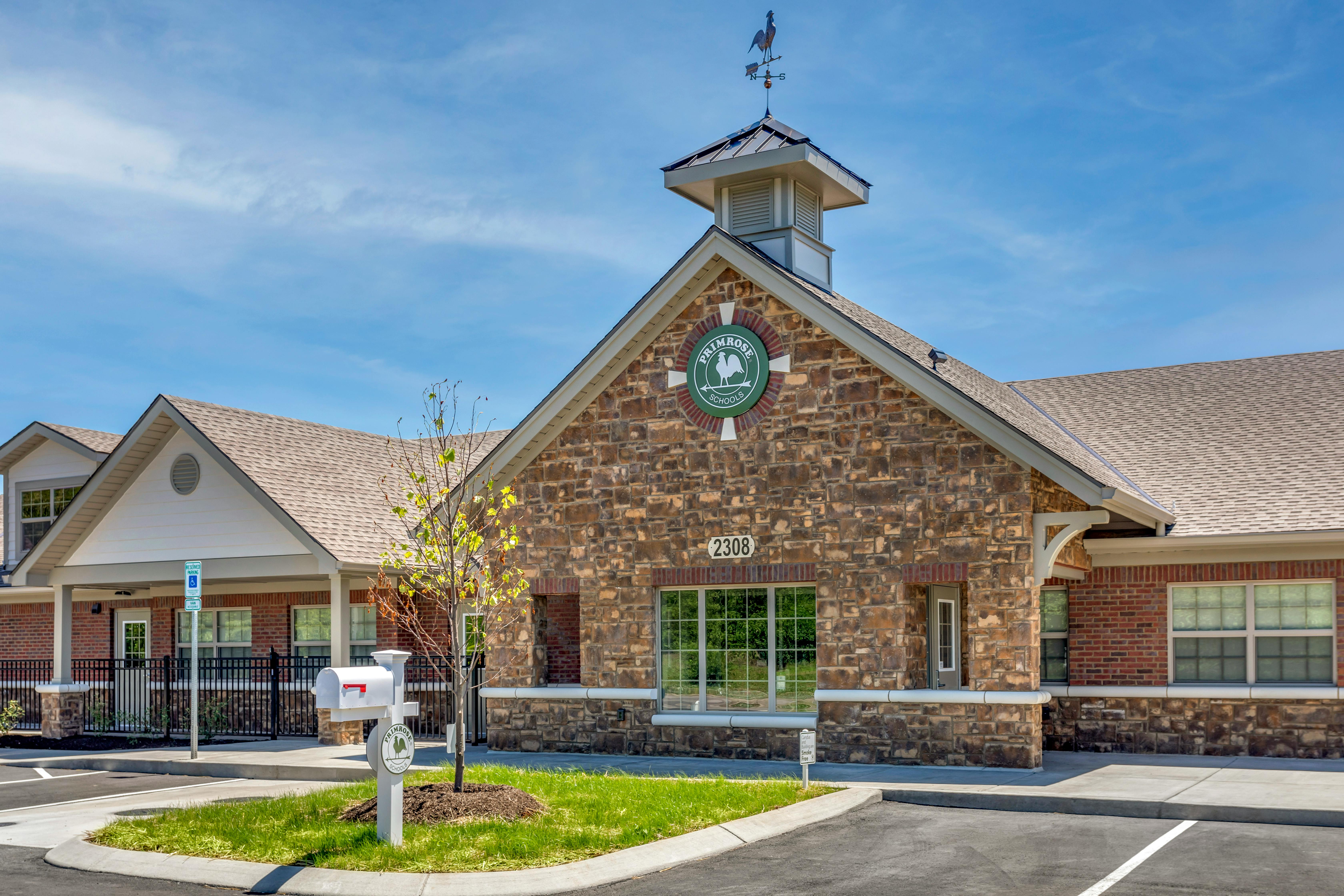 Front exterior of a Primrose Schools building with stone and brick facade