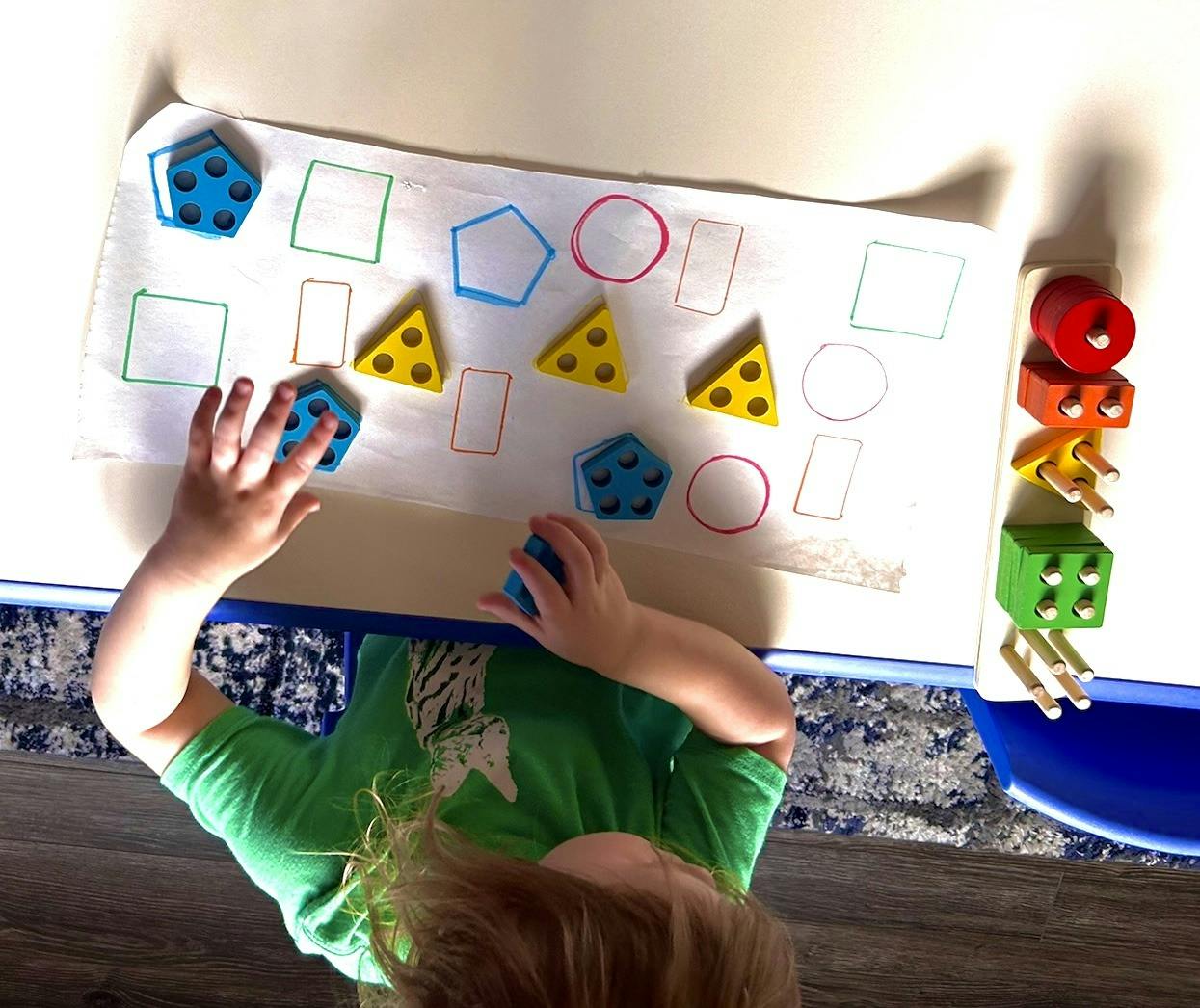 Child playing with shape sorter toy