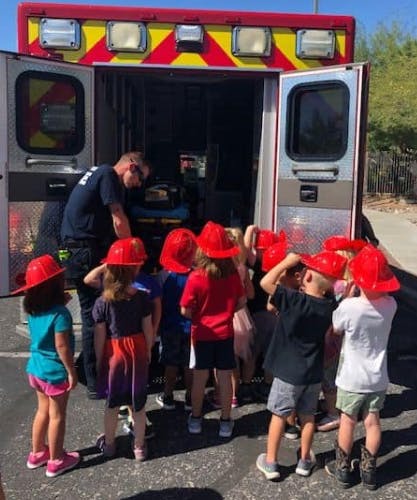 Person showing children an ambulance interior