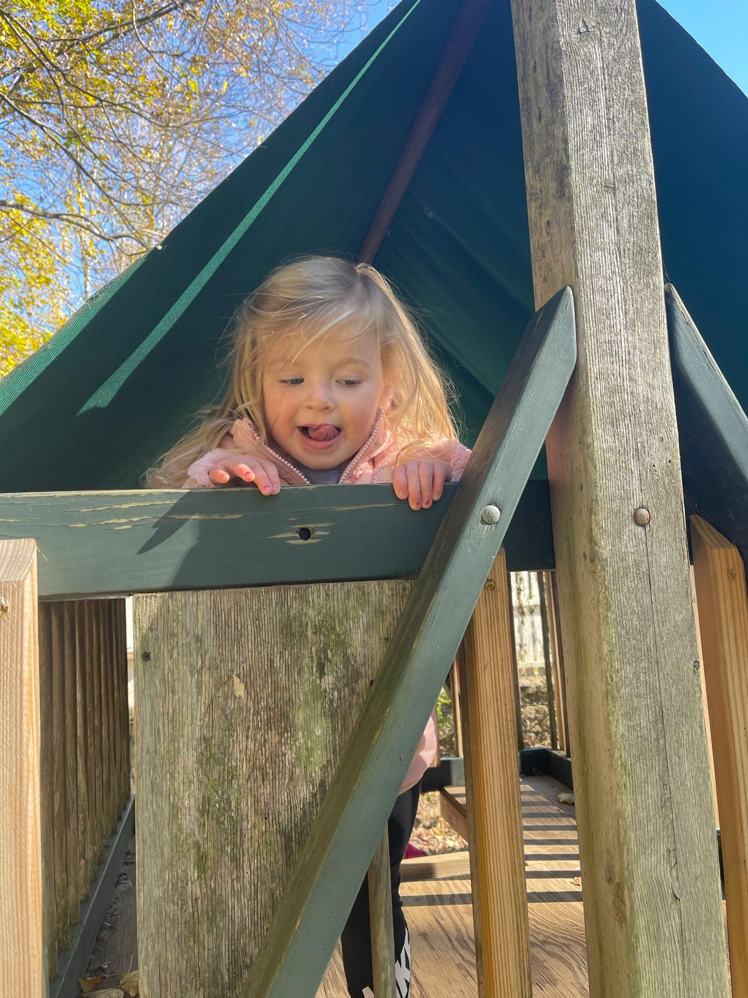 Child looking out from a play structure