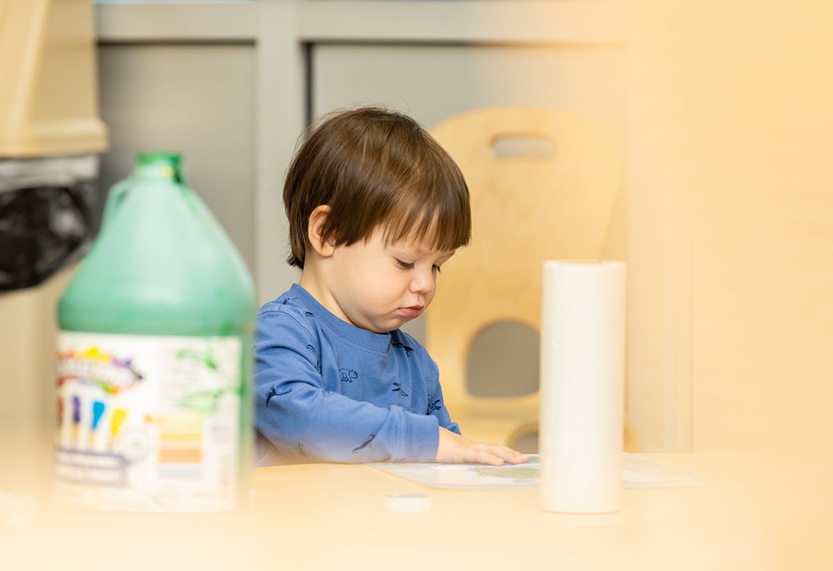 Child looking down at a table