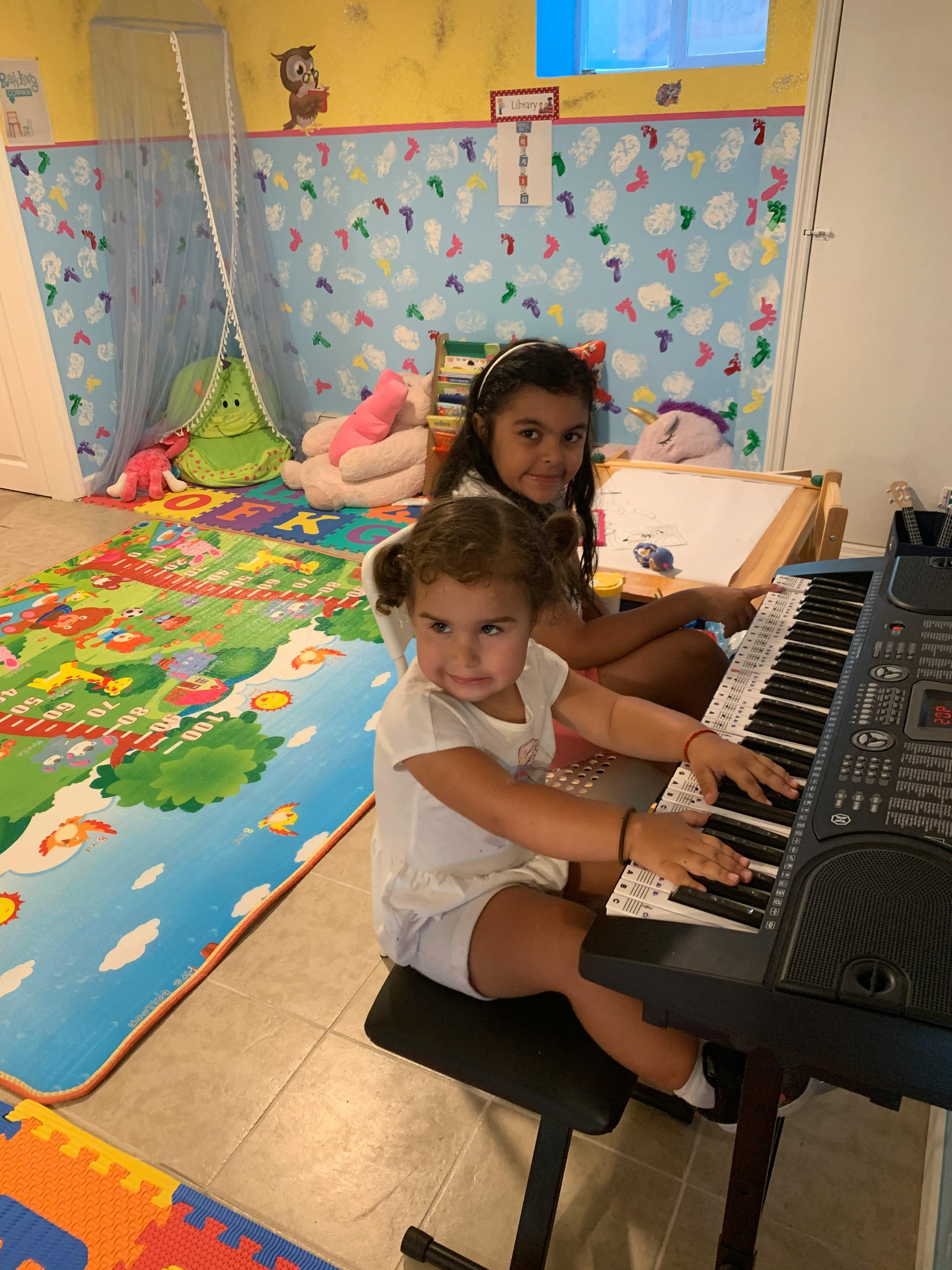 Two children playing a keyboard