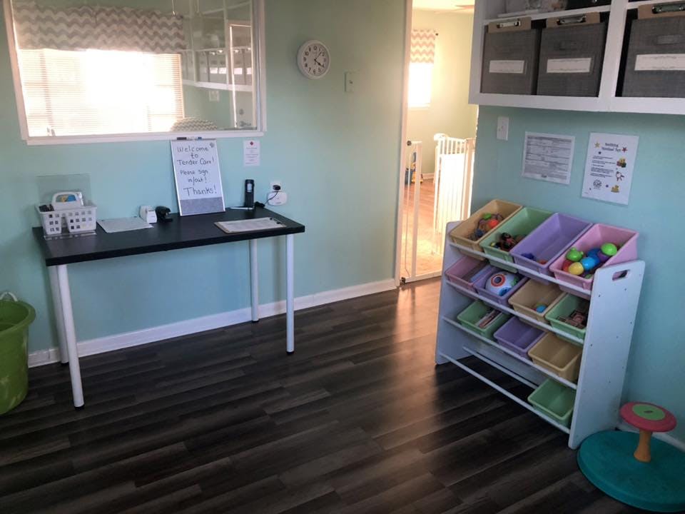 Desk with papers and a toy storage unit with colorful bins