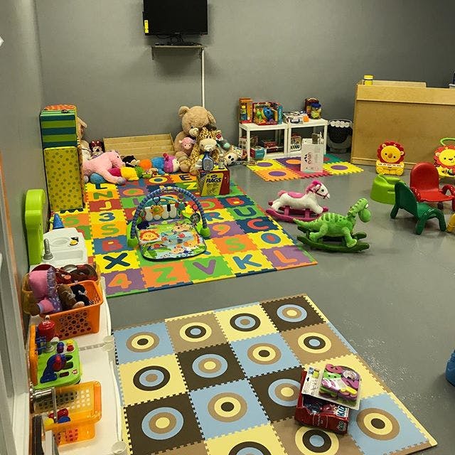 Playroom with colorful alphabet floor mats and various toys