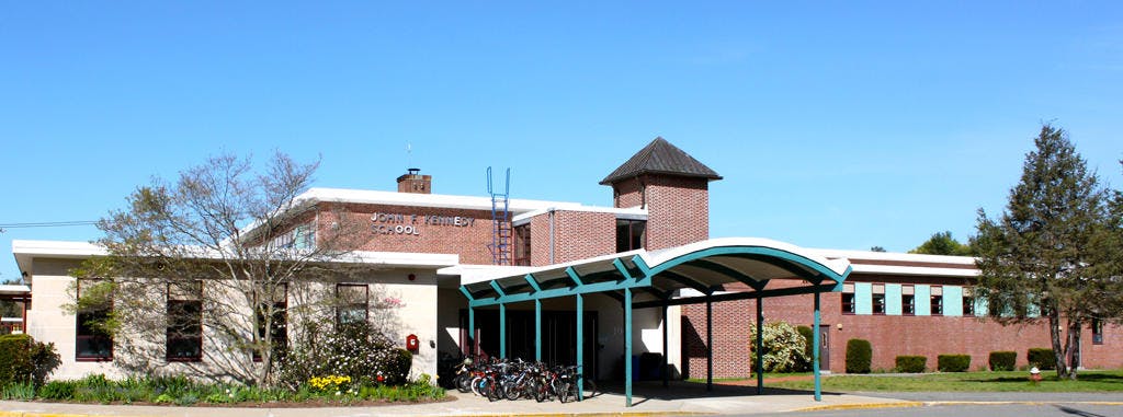 Brick building with a covered walkway and a small tower
