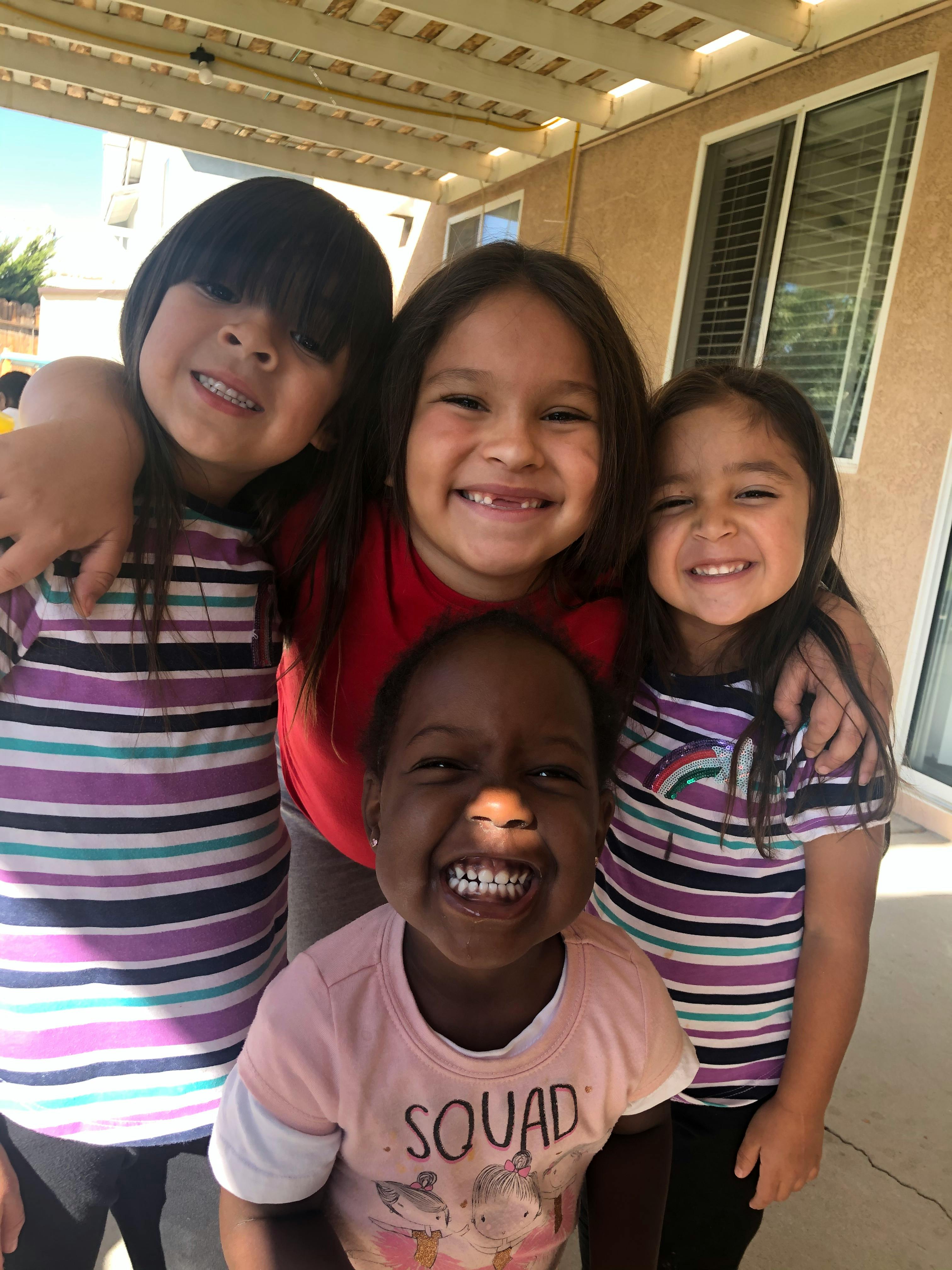 Four children smiling at the camera