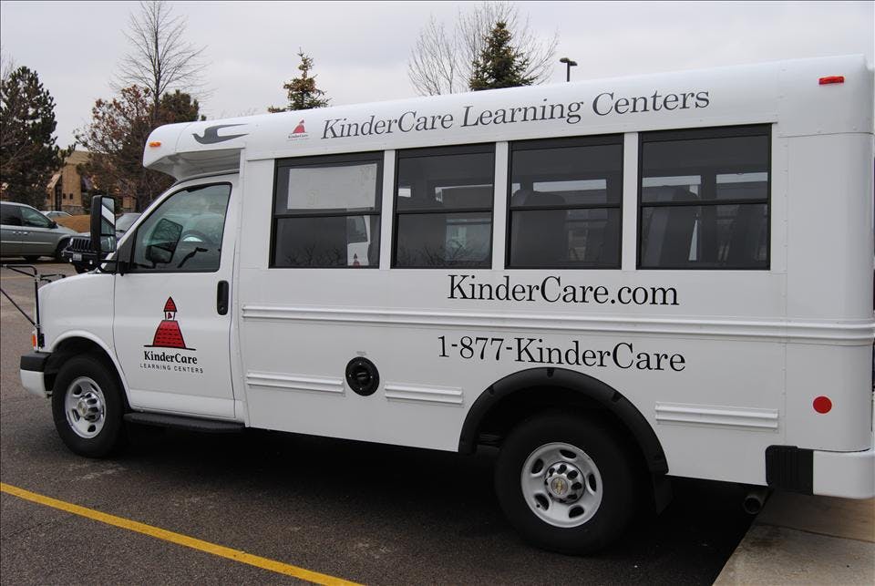 White KinderCare Learning Centers shuttle bus