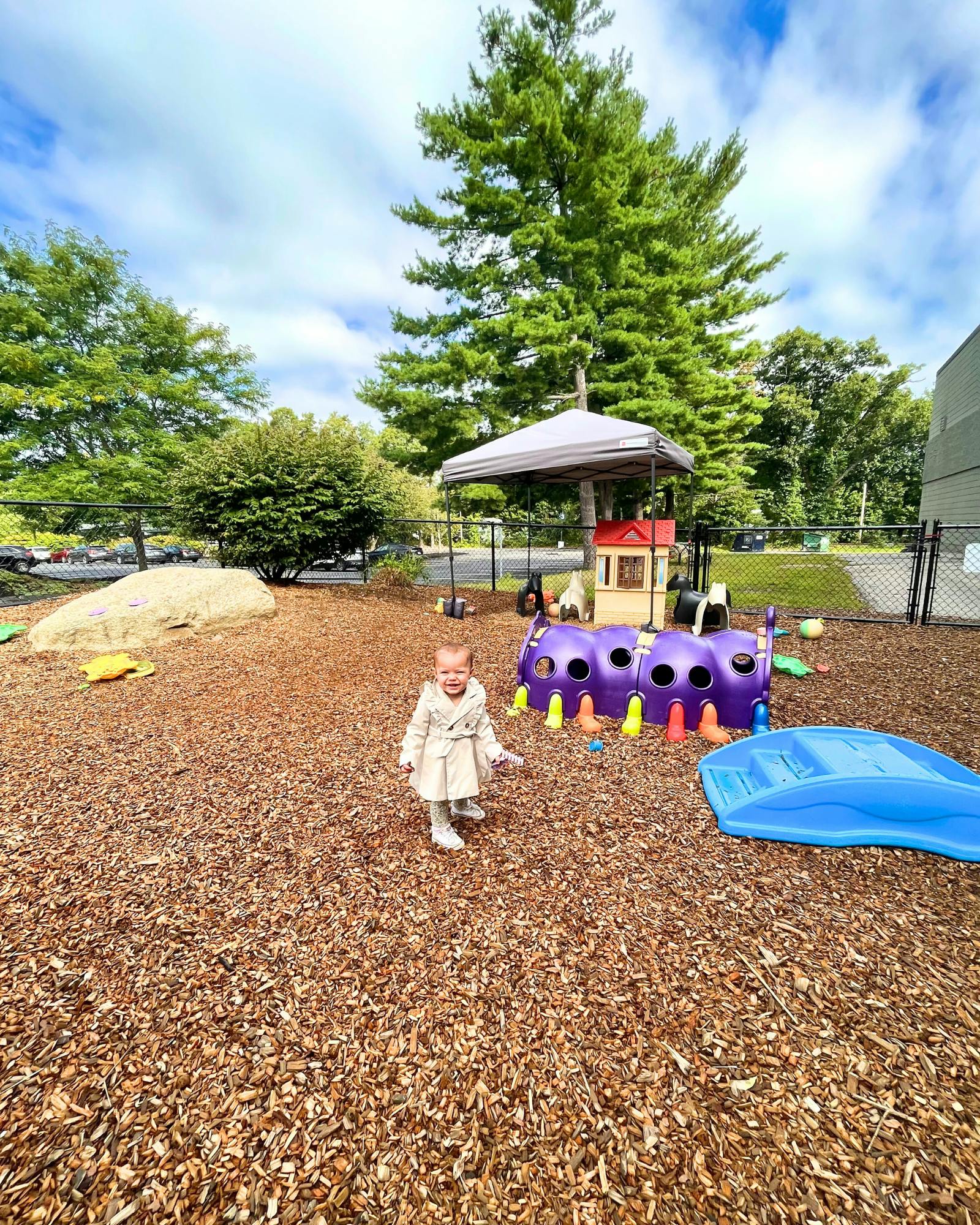 Child walking on wood chips in a playground