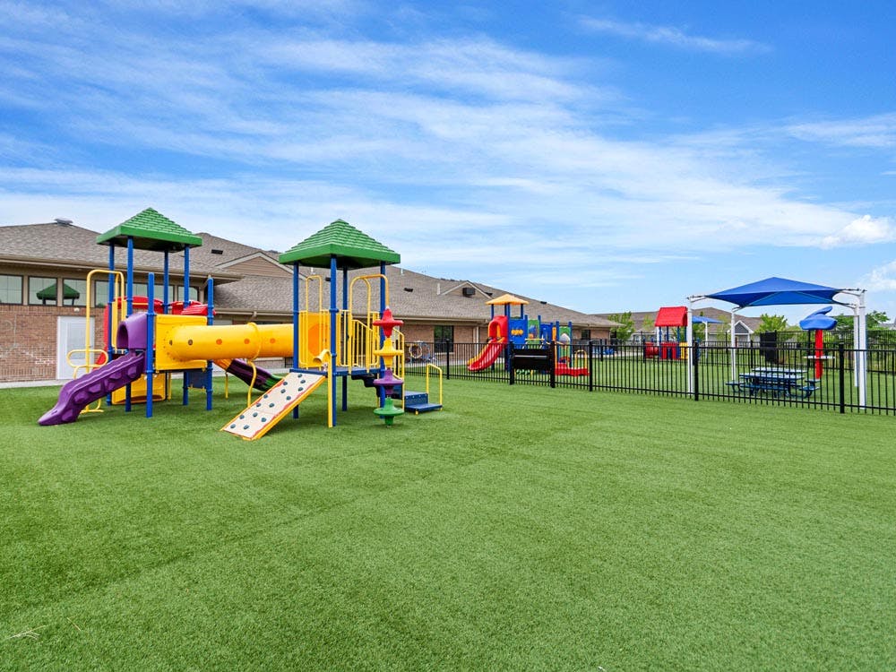 Colorful playground with slides and a tunnel on artificial turf