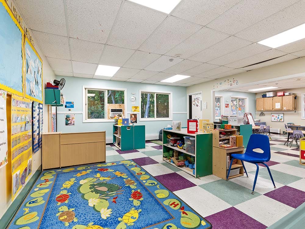 Classroom with checkered floor and blue rug
