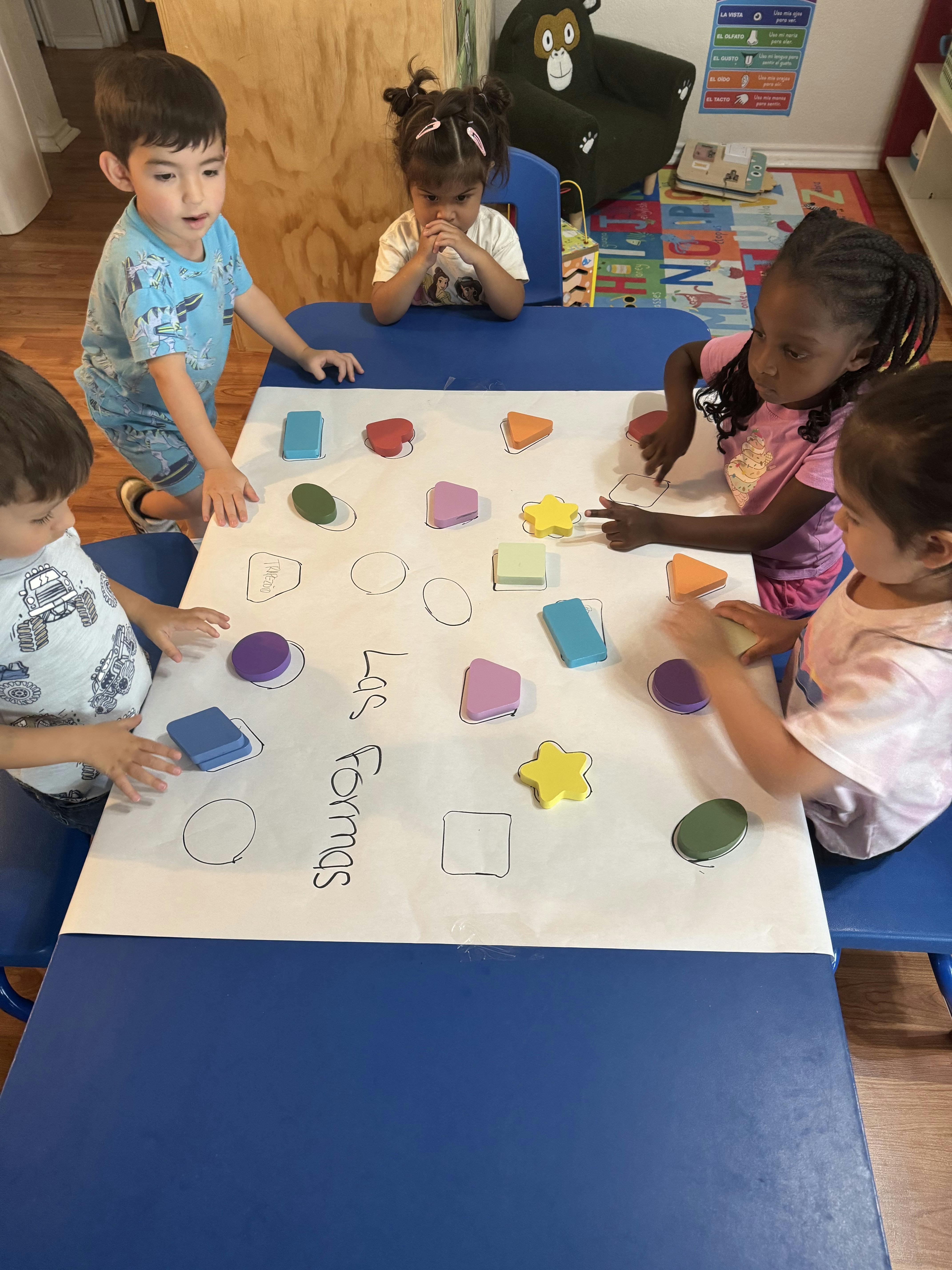 Children playing with shape blocks on a table