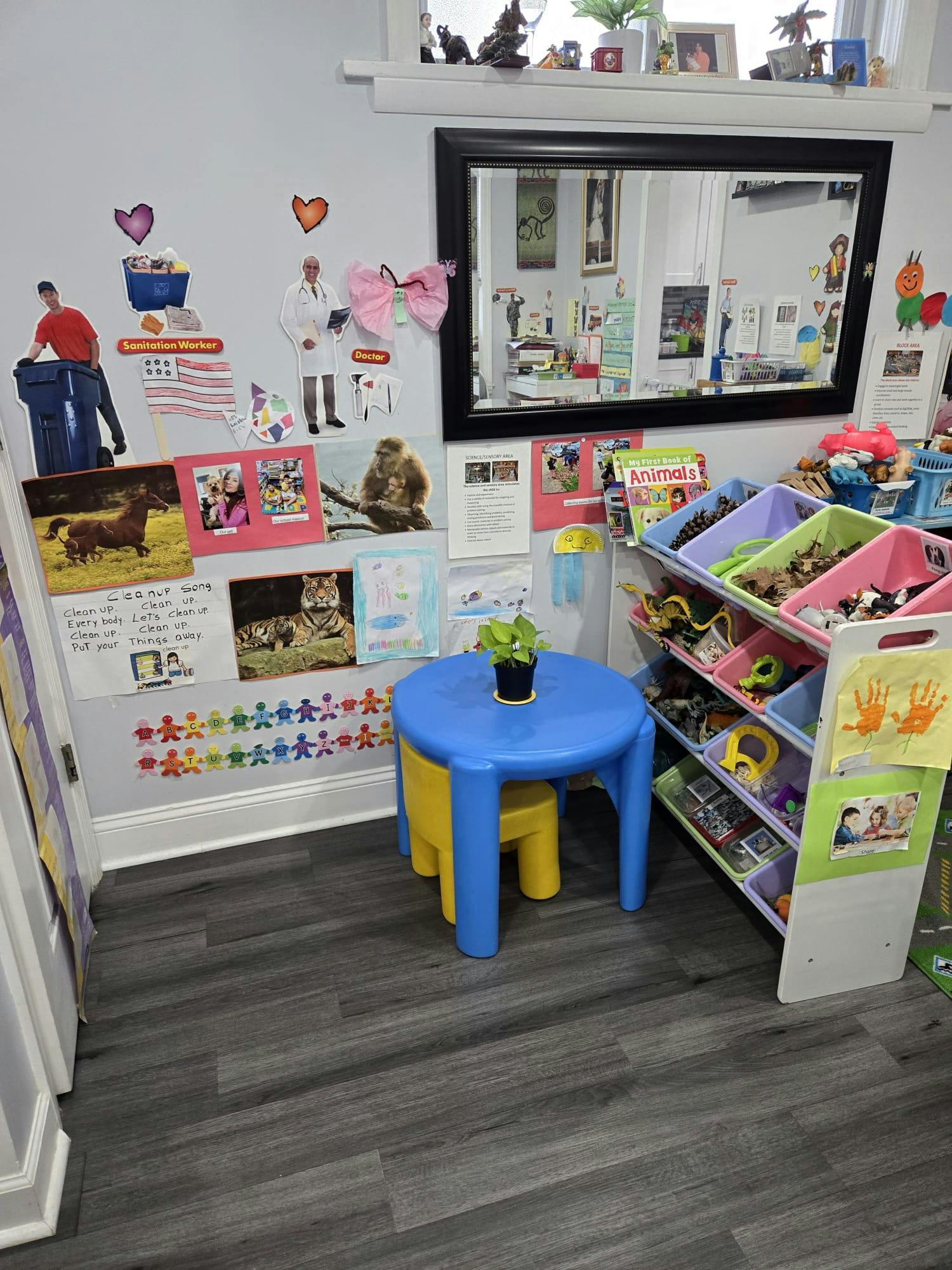 Child's playroom with a small table and storage bins filled with toys