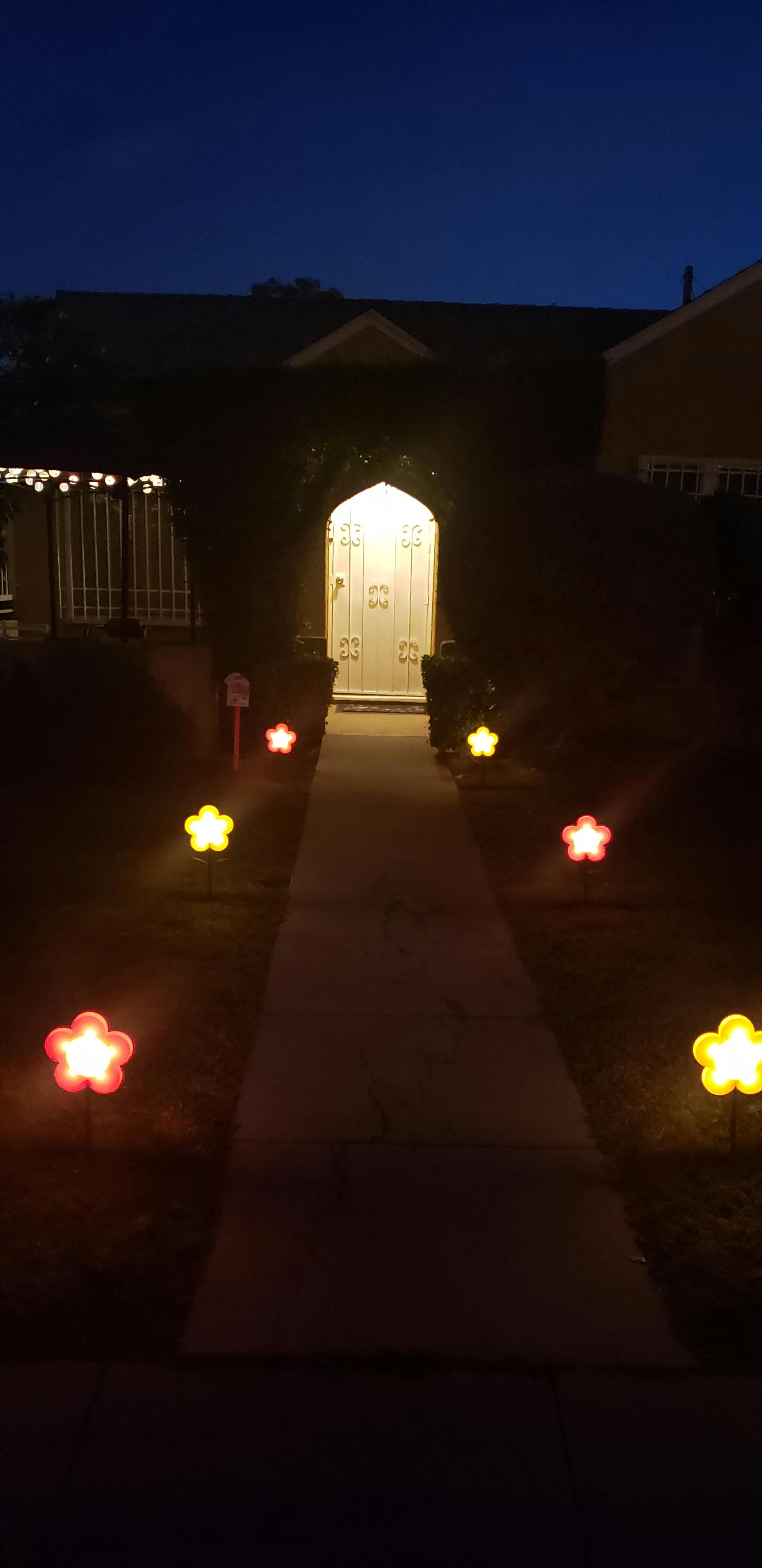 Walkway leading to a house entrance with star-shaped lights