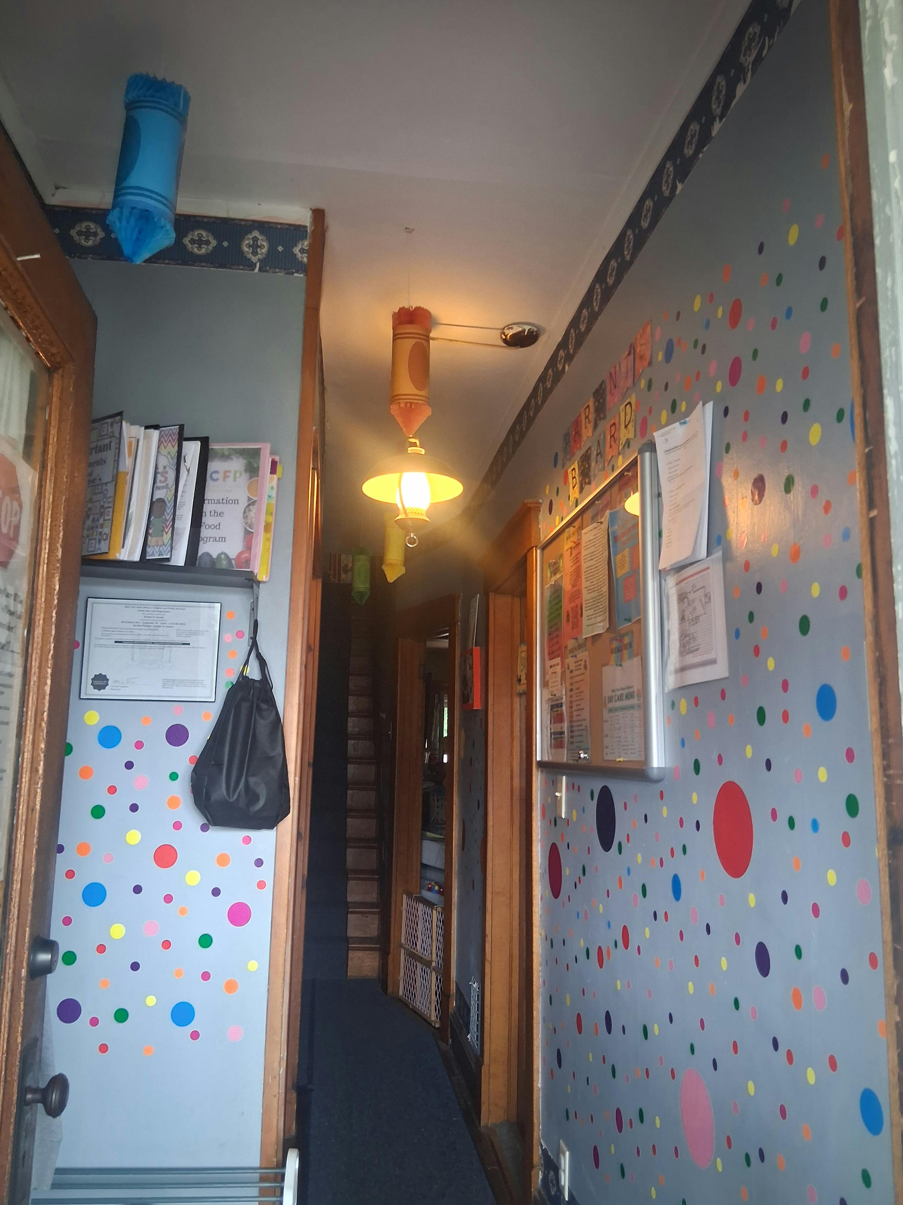 Hallway with polka dot walls and hanging lights