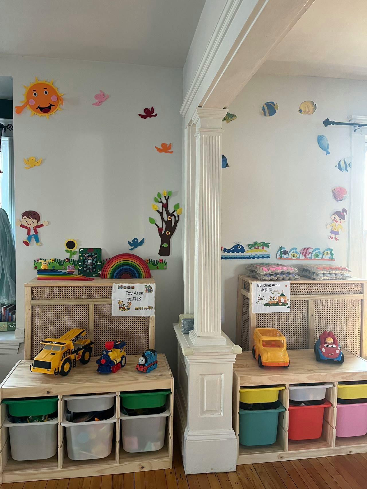 Two wooden storage units with toys and wall decorations in a room