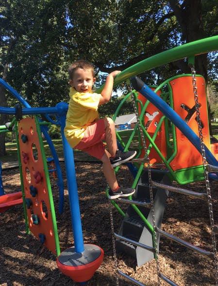Child climbing on playground equipment