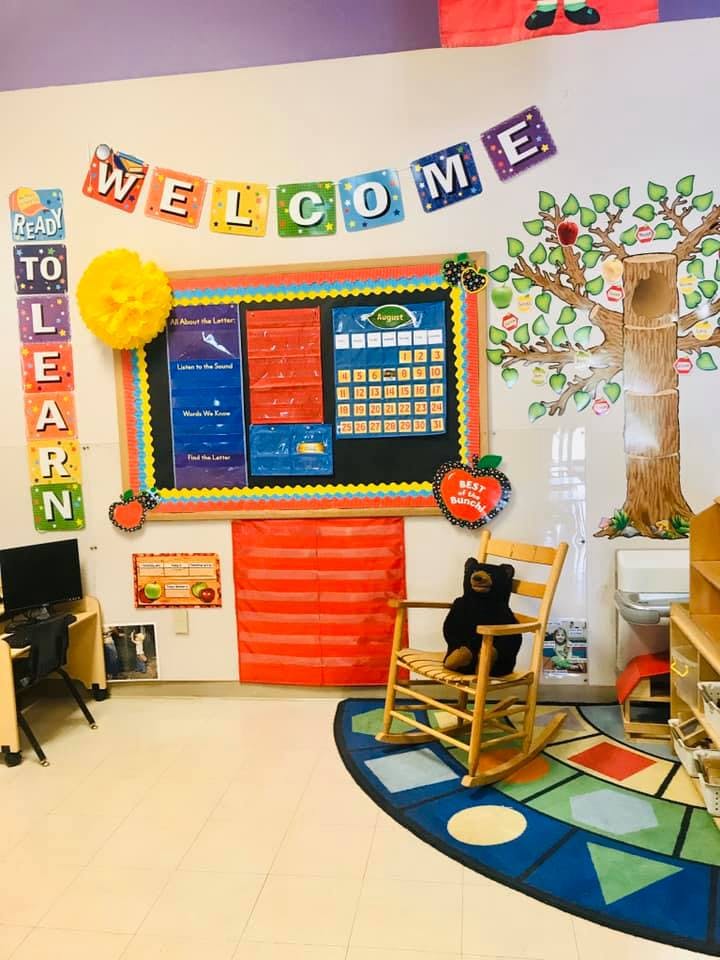 Classroom with a bulletin board, rocking chair, and a rug