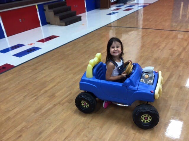 Child in a toy car