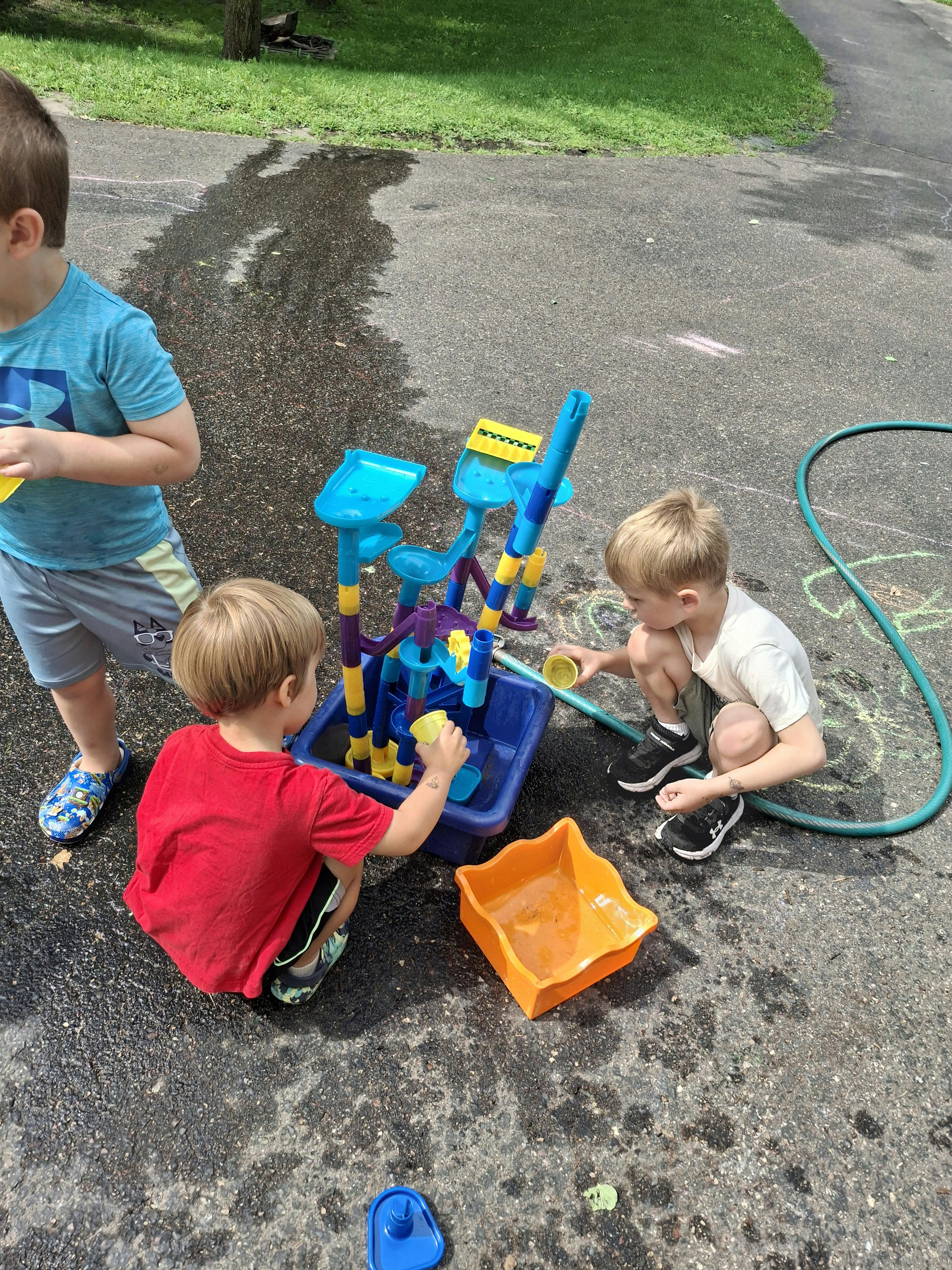 Children playing with a water table outdoors