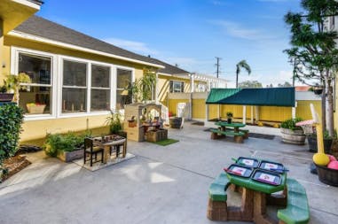 Outdoor play area with tables and play structures