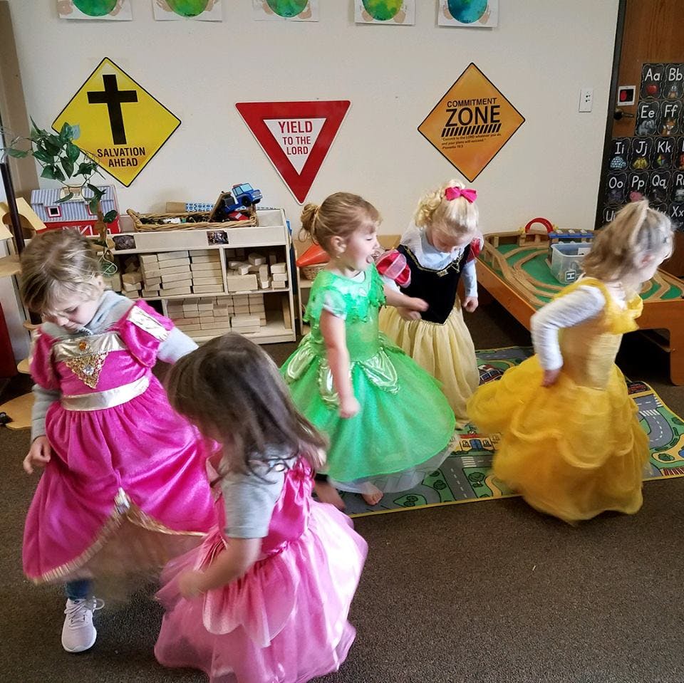 Children in costumes playing indoors