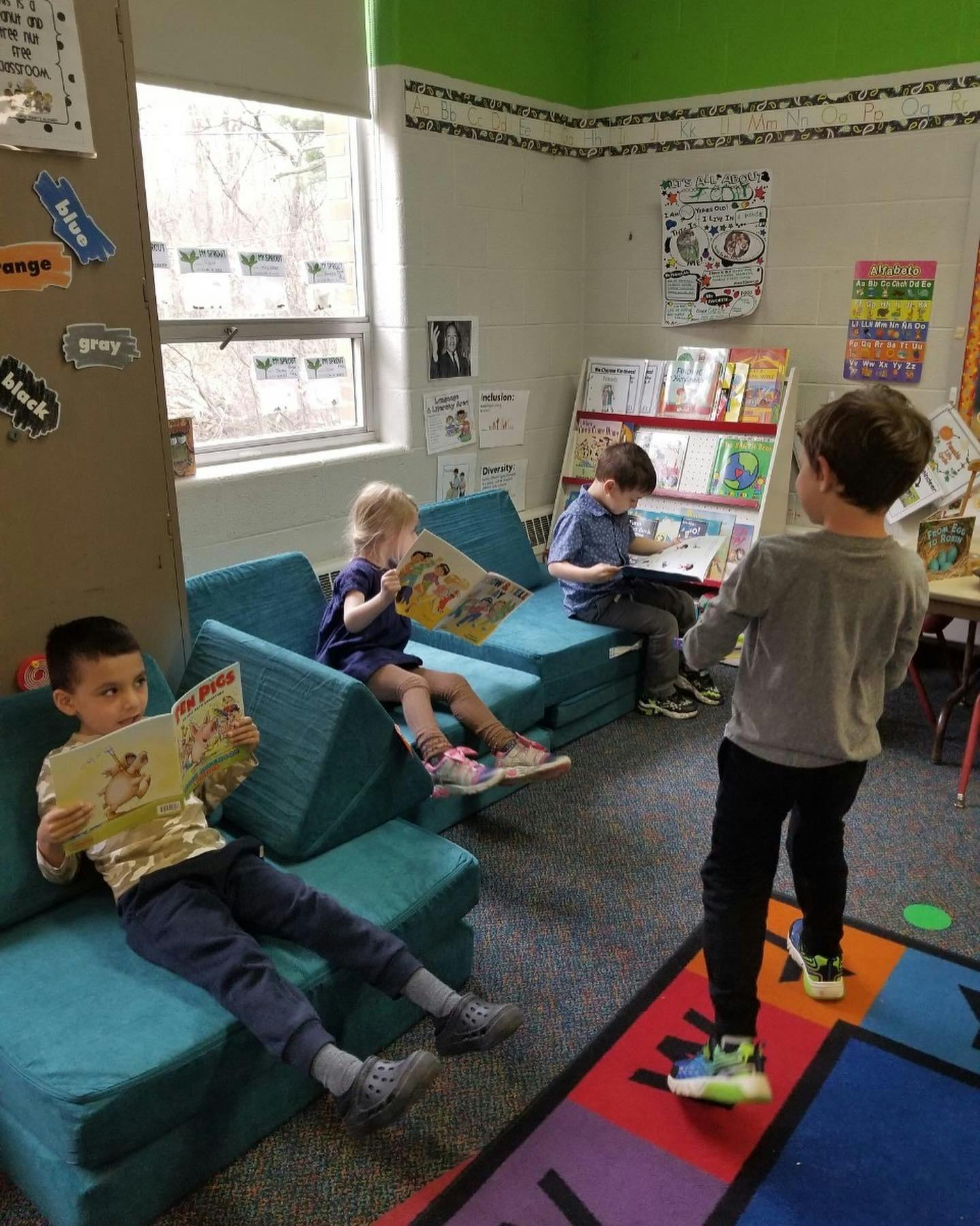 Children reading books in a classroom