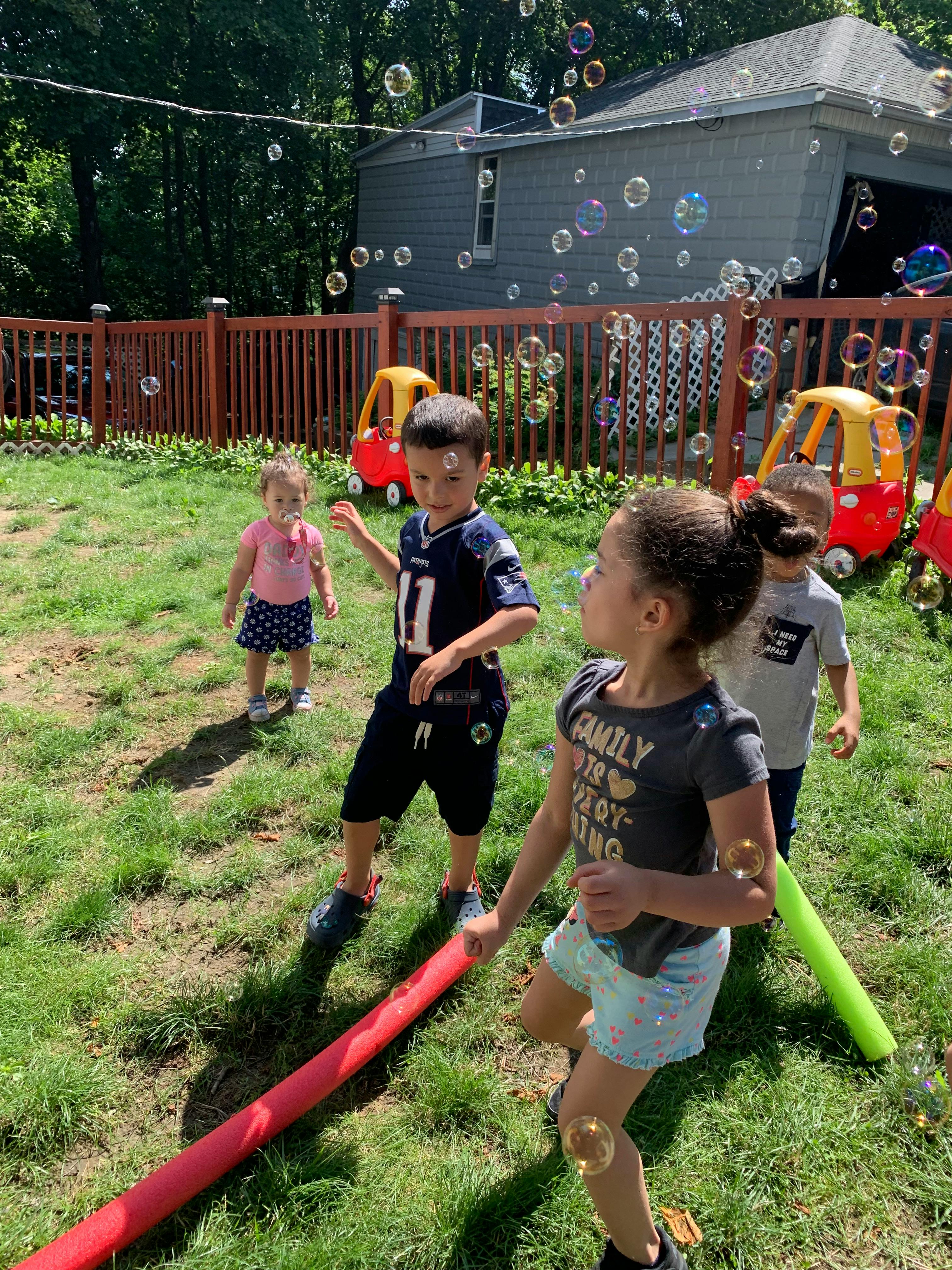 Children playing with bubbles outdoors