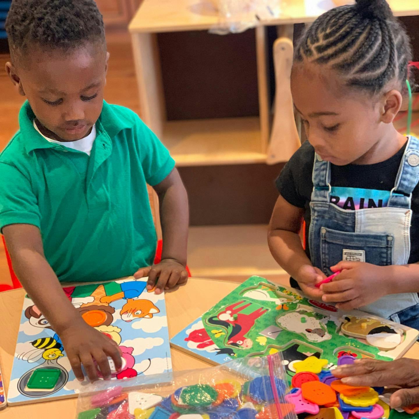 Two children playing with puzzles