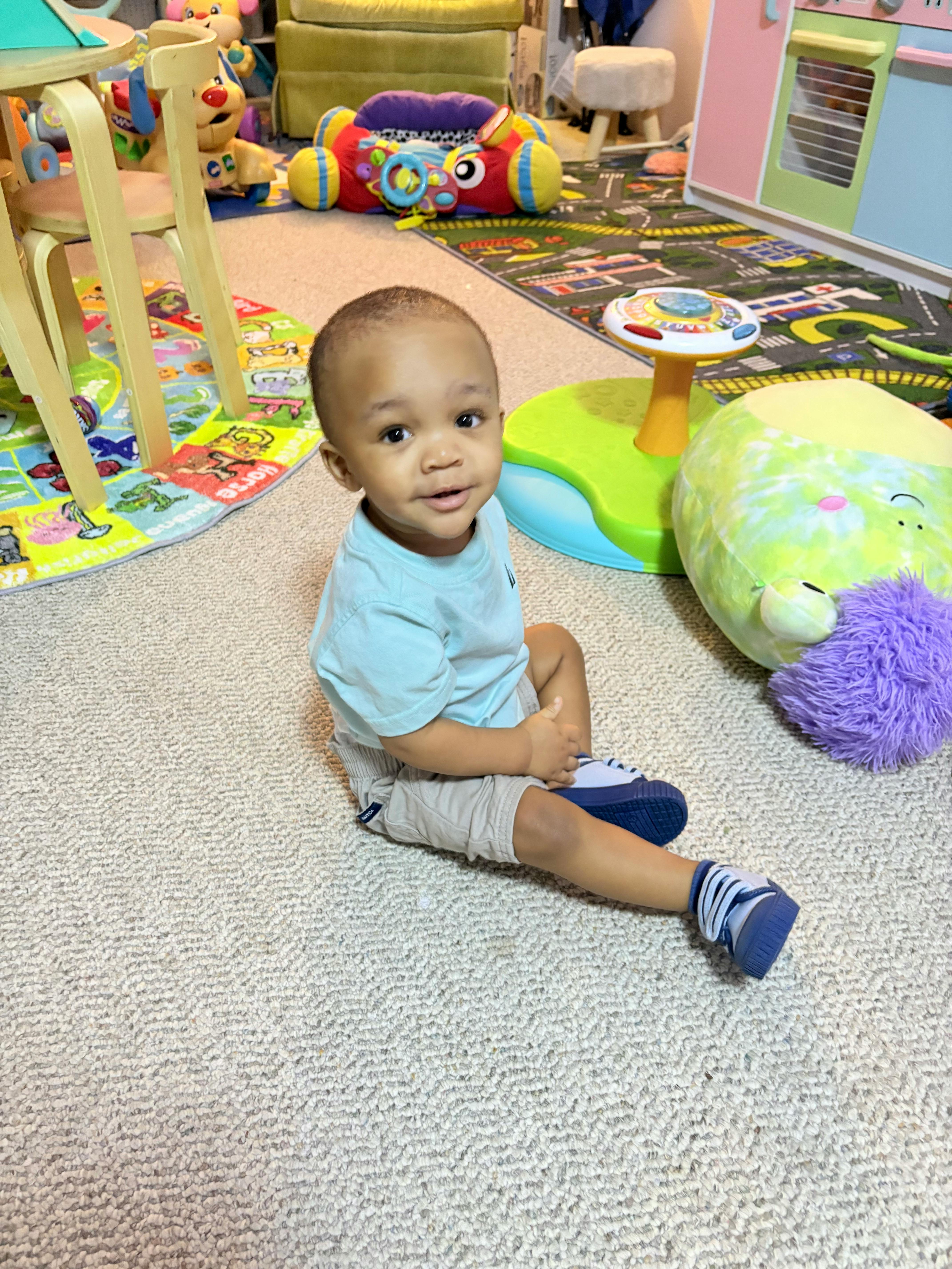 Child sitting on a carpeted floor