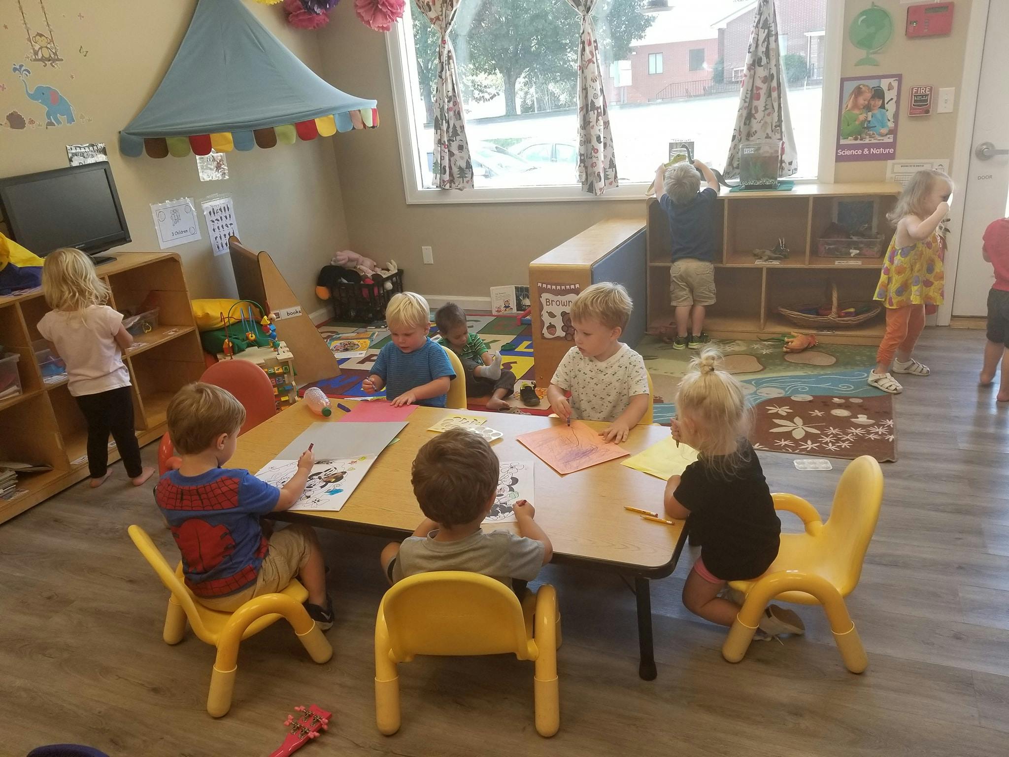 Children sitting at tables in a classroom