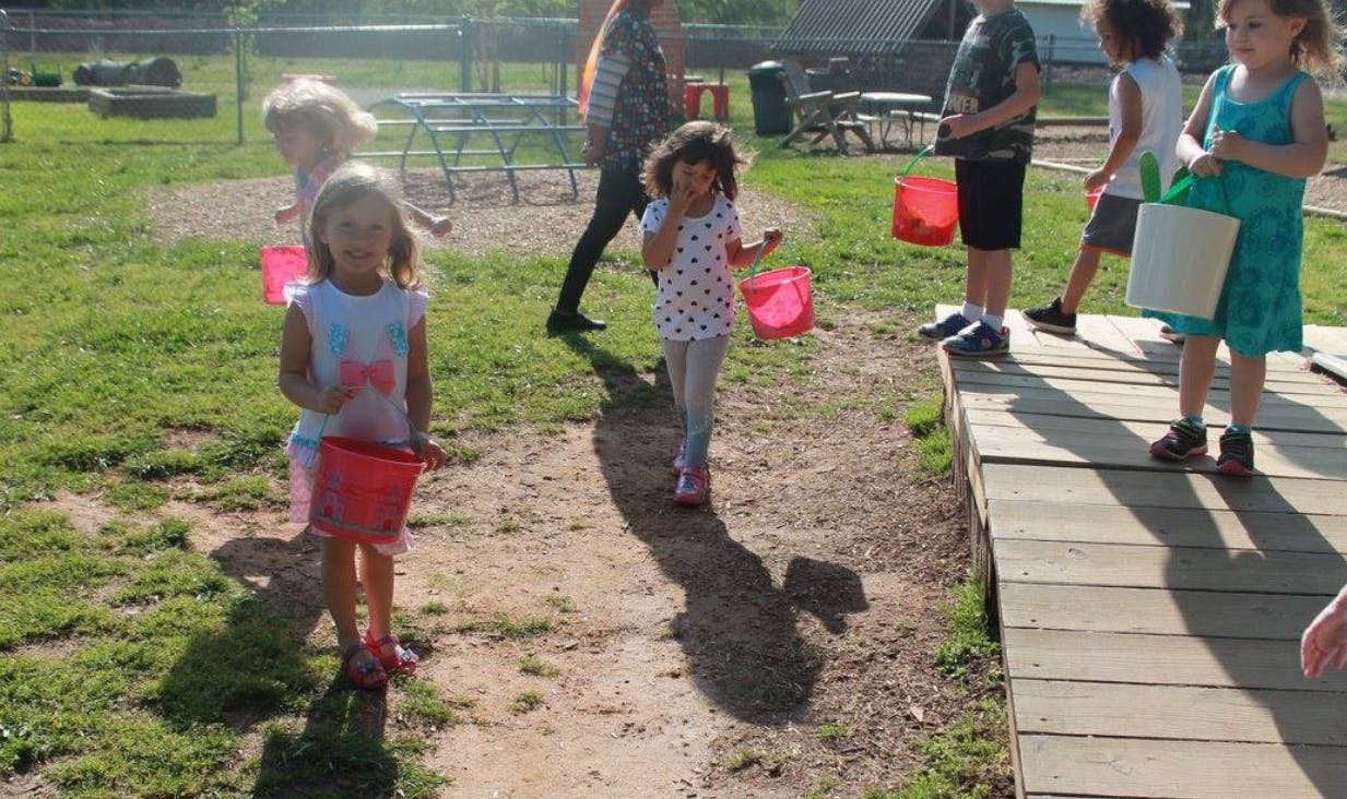 Children holding buckets outdoors