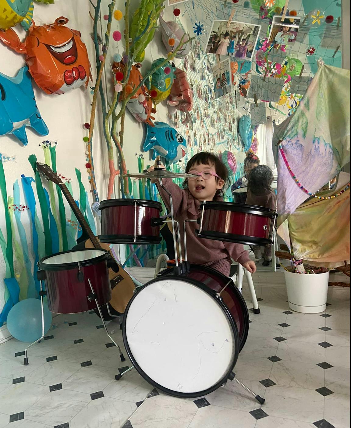 Child playing a drum set
