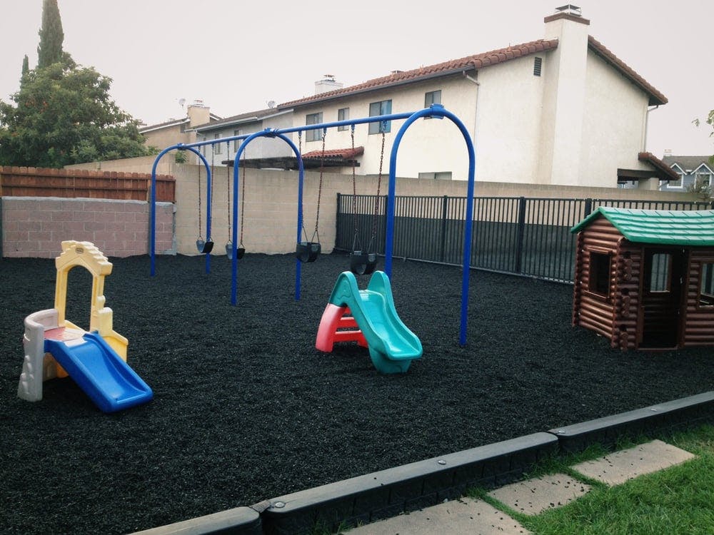 Playground with swings, slides, and a small playhouse