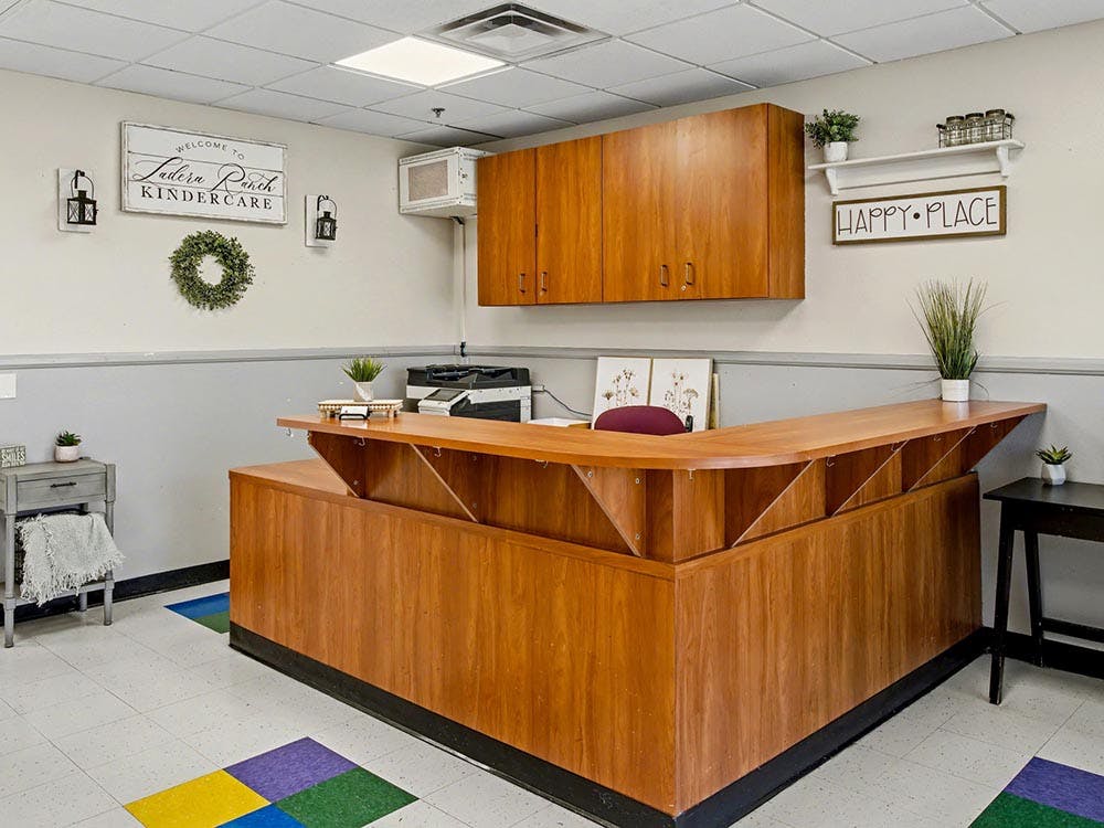 Reception desk in a childcare center with decorative signs on the wall