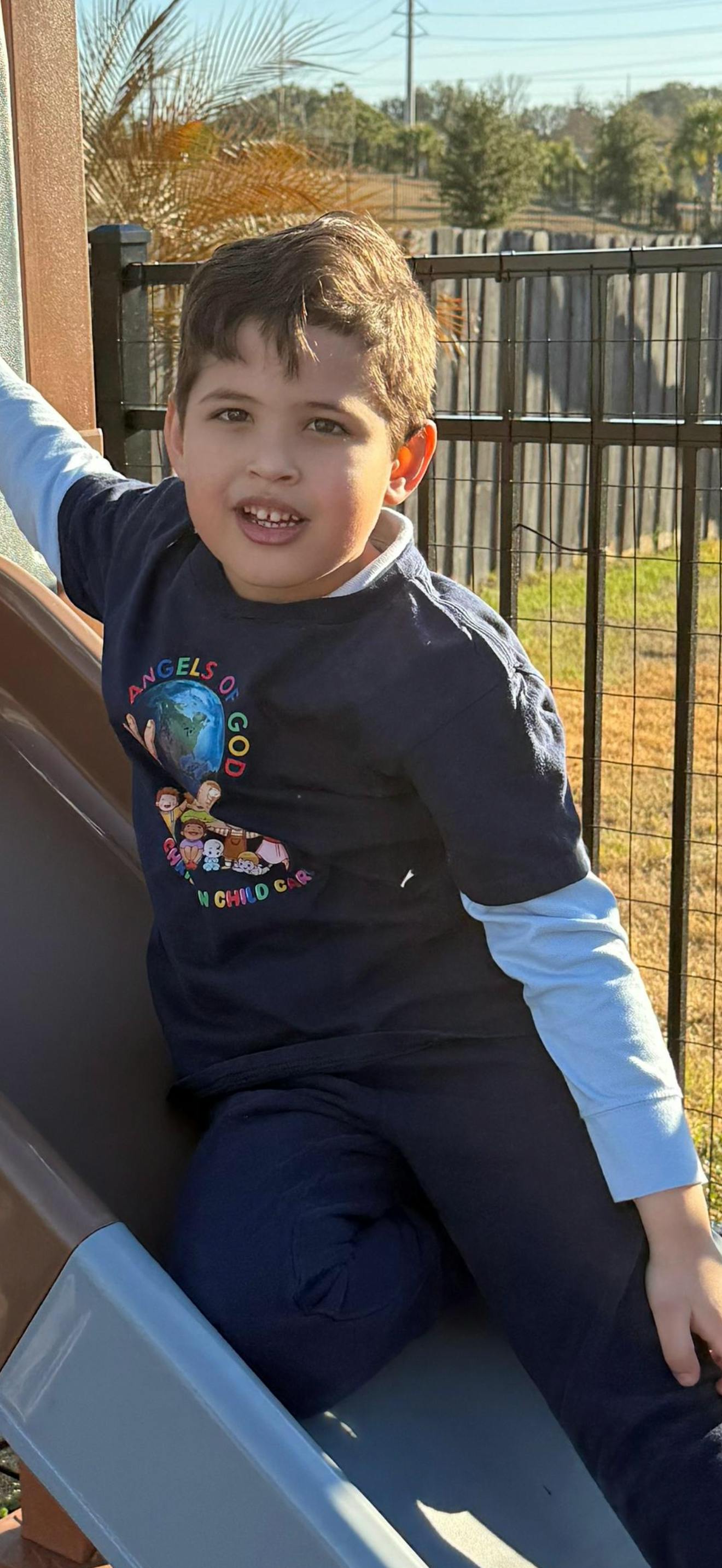 Child sitting on a playground slide