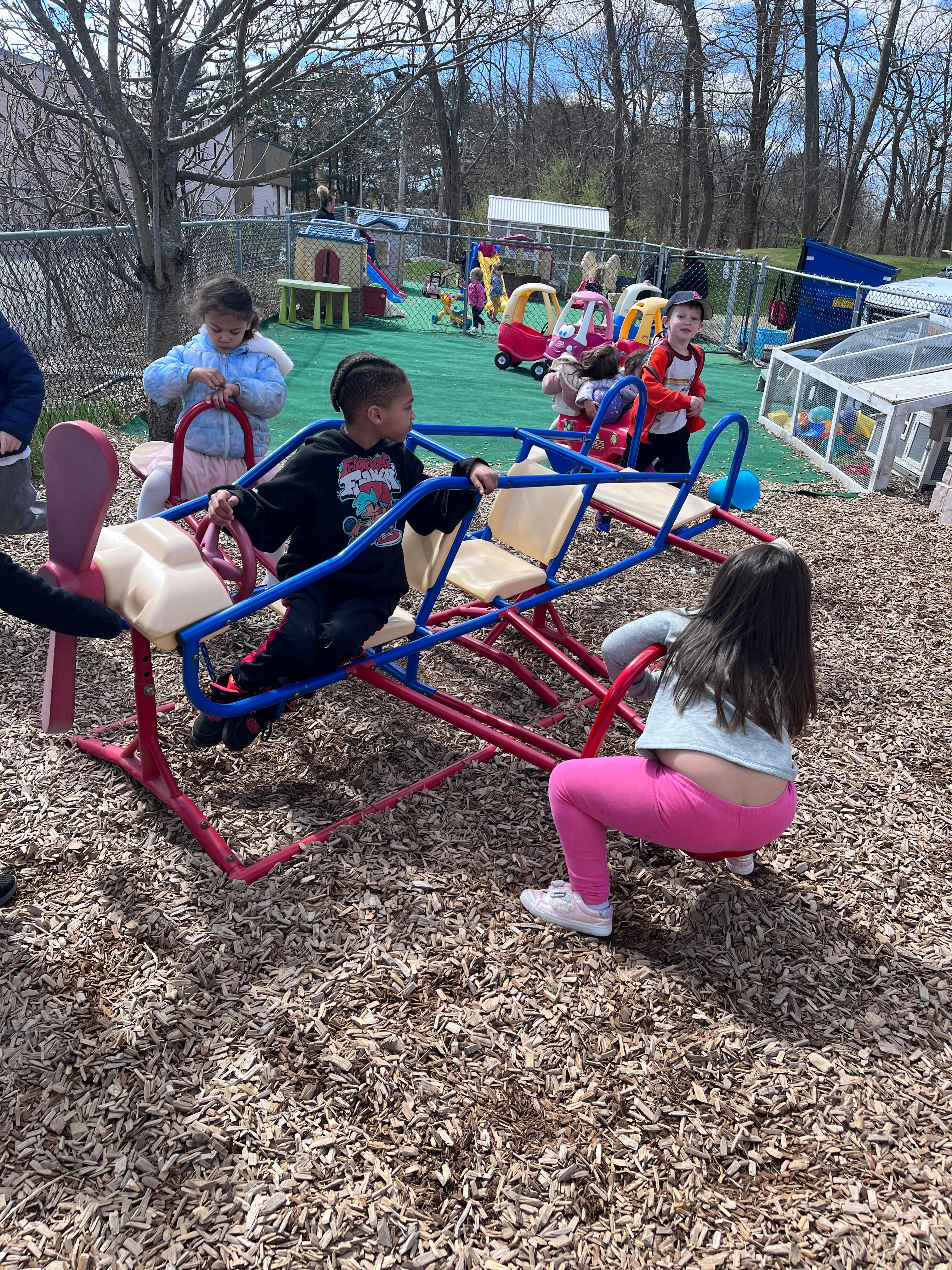 Children playing on a seesaw at a playground