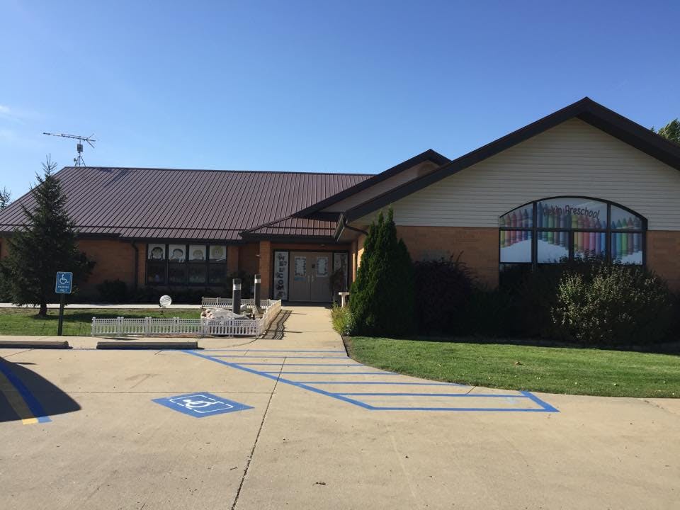 Building exterior with a paved walkway and a handicap parking space