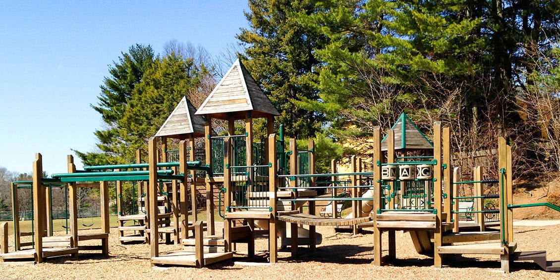 Wooden playground structure with green accents